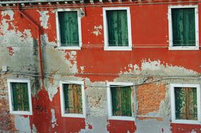 Orange facade of an old building with torn wall