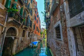 photo of a boat on a narrow city canal