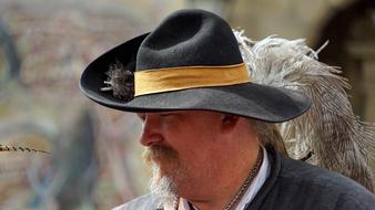 photo of a man in a medieval hat with feathers