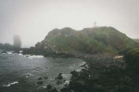 scenic rocky coast on foggy weather