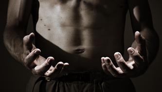 black and white photo of the hands of a sporty young man