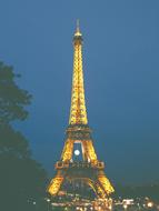 yellow illumination of the Eiffel tower in Paris at night