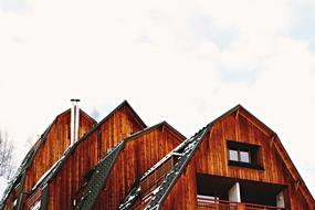 winter photo of the roof of a wooden cottage