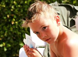 photo of a boy with playing cards