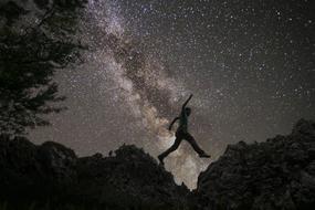 Man Jumping at starry sky