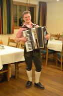 man plays Accordion in ethnic restaurant