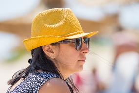 profile portrait of a woman in a yellow hat