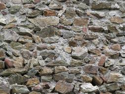 sharp stones sticking out of the stone wall