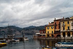 Beautiful landscape of the Garda Lake, near the colorful houses, in Malcesine, Italy, near the mountains, under the clouds