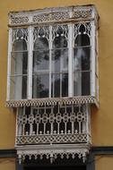 Beautiful, patterned, glazed balcony, with the windows, of the vintage house