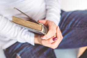 Hands holding Book Reading