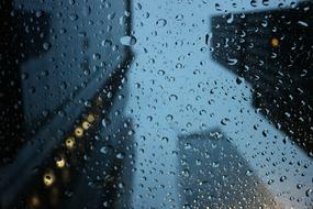 photo of skyscrapers through a wet car windshield