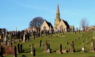 photos of tombstones and chapel on the hill
