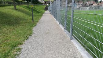 path along fenced Sports Ground