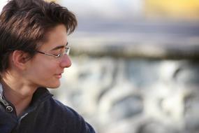 man with glasses close-up on blurred background