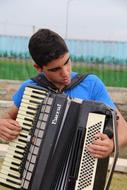 young boy play vintage Accordion