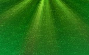 sun rays on a field with green grass