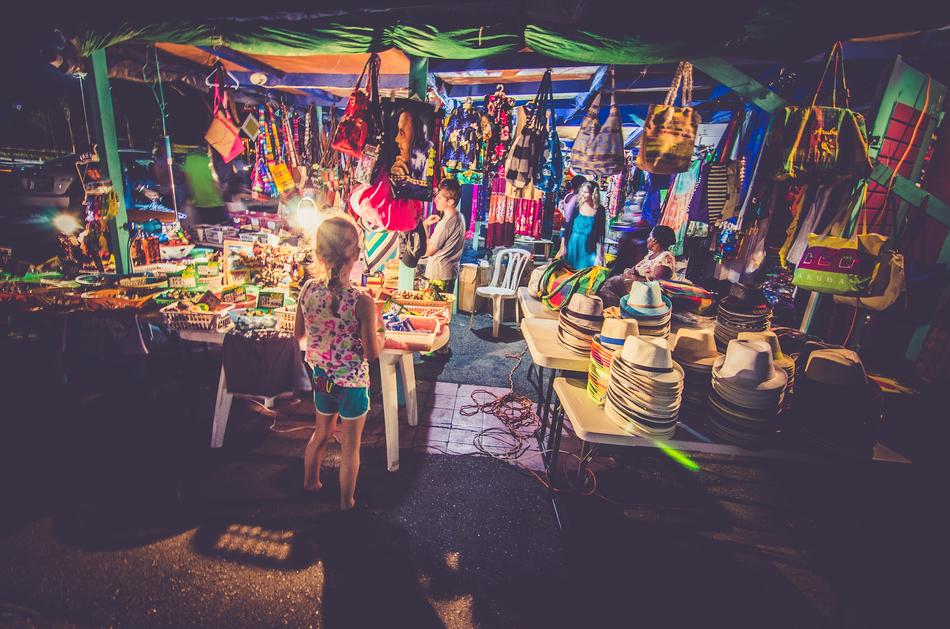child girl in front of Market stall with souvenirs