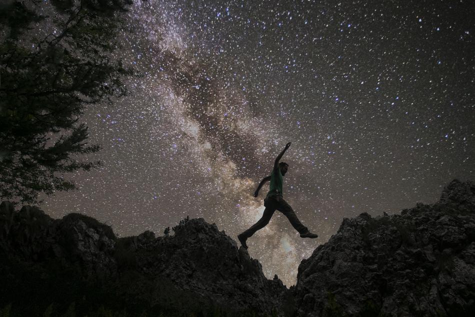 Man Jumping at starry sky