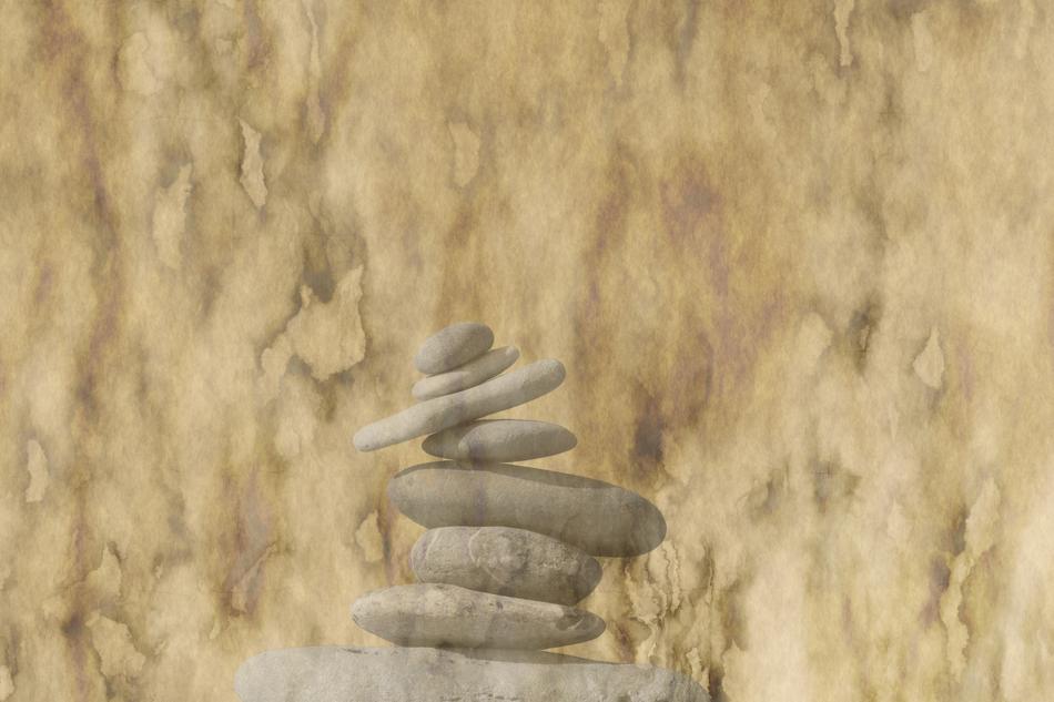 tower of stones on a brown paper background