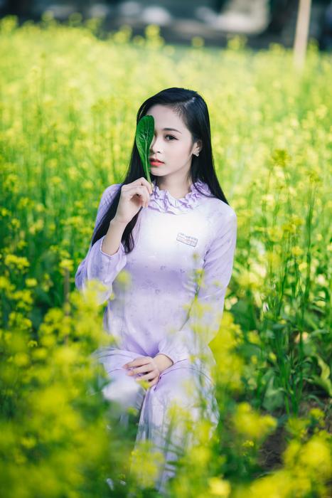 beautiful girl among flowers in the meadow