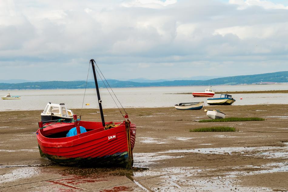 red boat on the beach by the sea