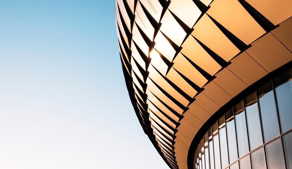 Shiny, modern architecture with the windows, at gradient, blue and white sky