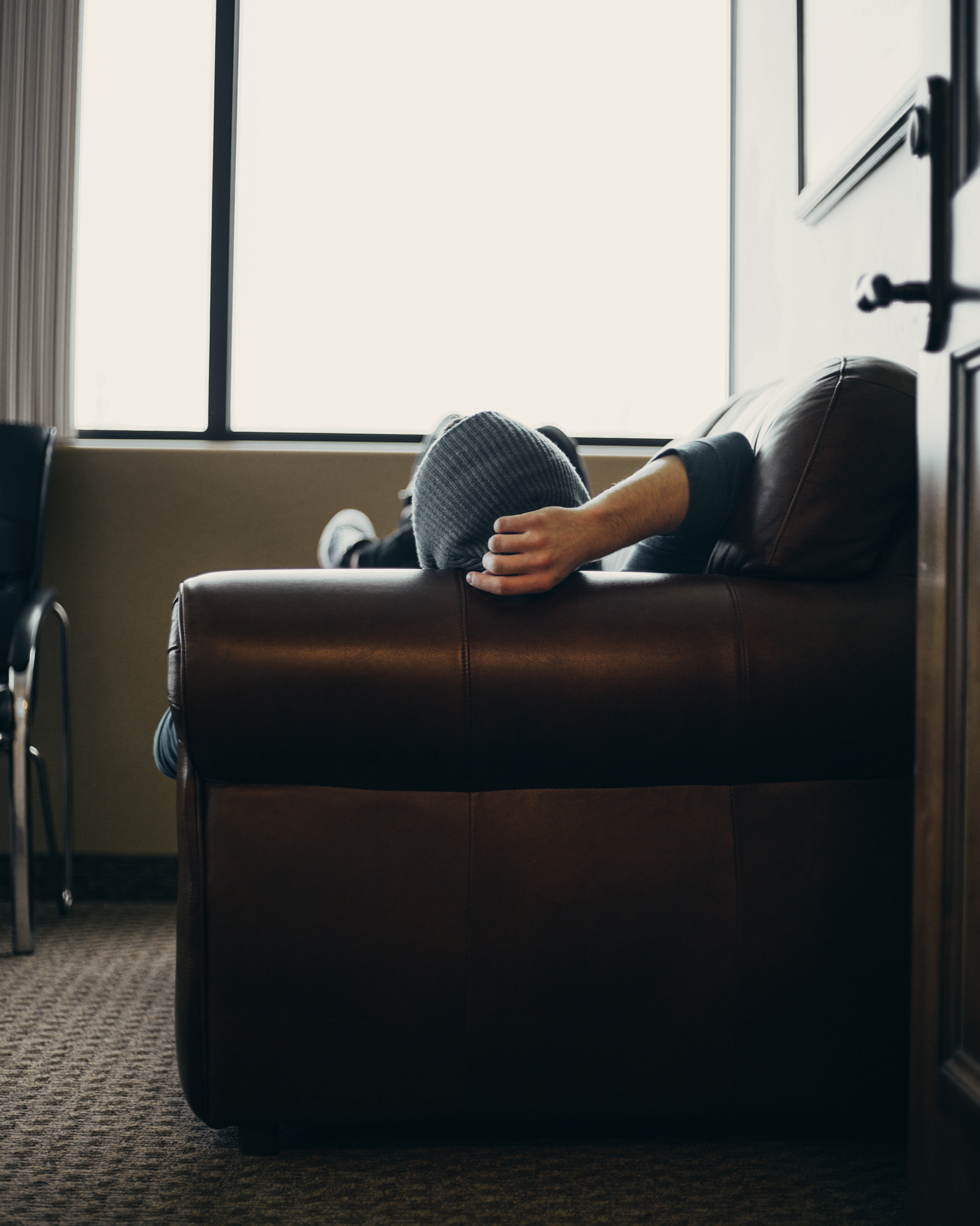 Man on the leather sofa in the room free image download