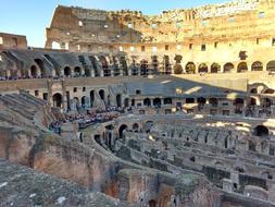 People in the beautiful Colosseum in shadow and light in Rome, Italy