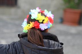 little girl with flowers on her head, back view