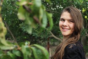 Portrait of a smiling girl among the green plants