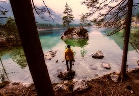 man on the shore of a mountain lake in Austria