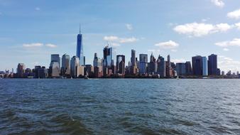 Beautiful and colorful shore of Manhattan in New York, USA, under the blue sky with clouds