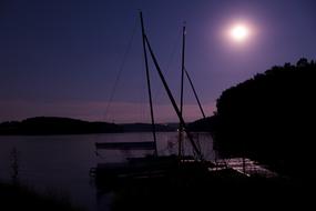 Beautiful landscape with the pier with the boat, at the night, at the colorful and beautiful sky