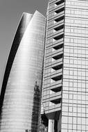 Black and white photo of the shiny architecture with the glass facades