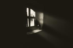 Light through the window of the house, with the lamp on the window, among the darkness