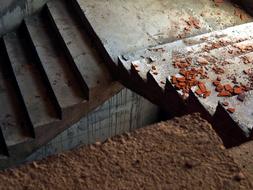 Pieces of the red bricks, on the staircase in light and shadow