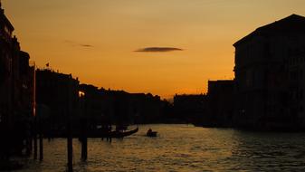 Silhouettes of the buildings, around the beautiful canal, at colorful and beautiful sunset, in Venice, Italy
