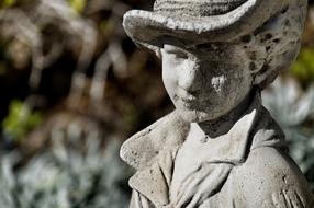 Stone Boy as a sculpture in a park
