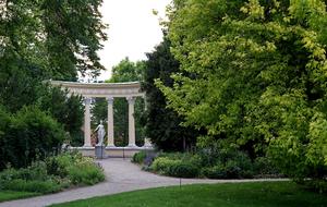 a stone arch in a beautiful park