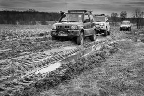 military vehicles drive through the mud