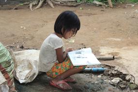 Kid Reading Book on street