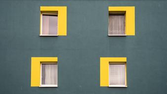 windows with yellow slopes on the house