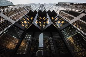 evening photo of the corners of a glass skyscraper