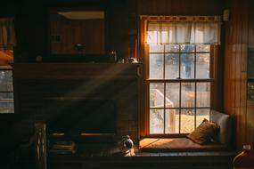 bed near the window in the interior of the old room