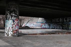 graffiti on the walls under the bridge