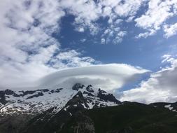 cloud on peak of snowy Mountain at Blue Sky