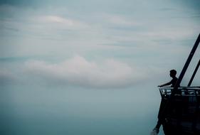 guy on the deck of a ship on a background of clouds