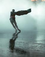 photo of a man during a storm on a background of fog