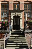 Beautiful and colorful house entrance in GdaÅsk, Poland, with the colorful plants, in sunlight